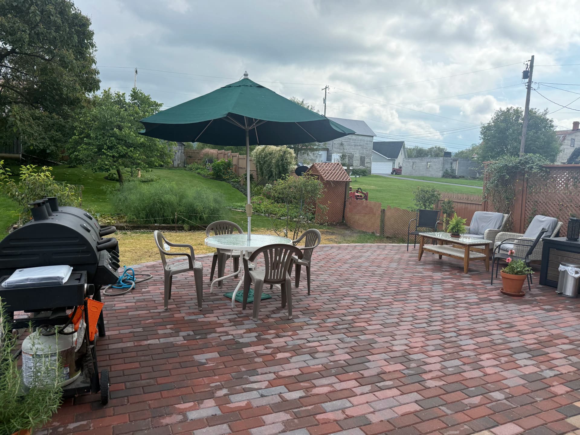 Paver Patio With Retaining Wall and Fresh Planting Beds
