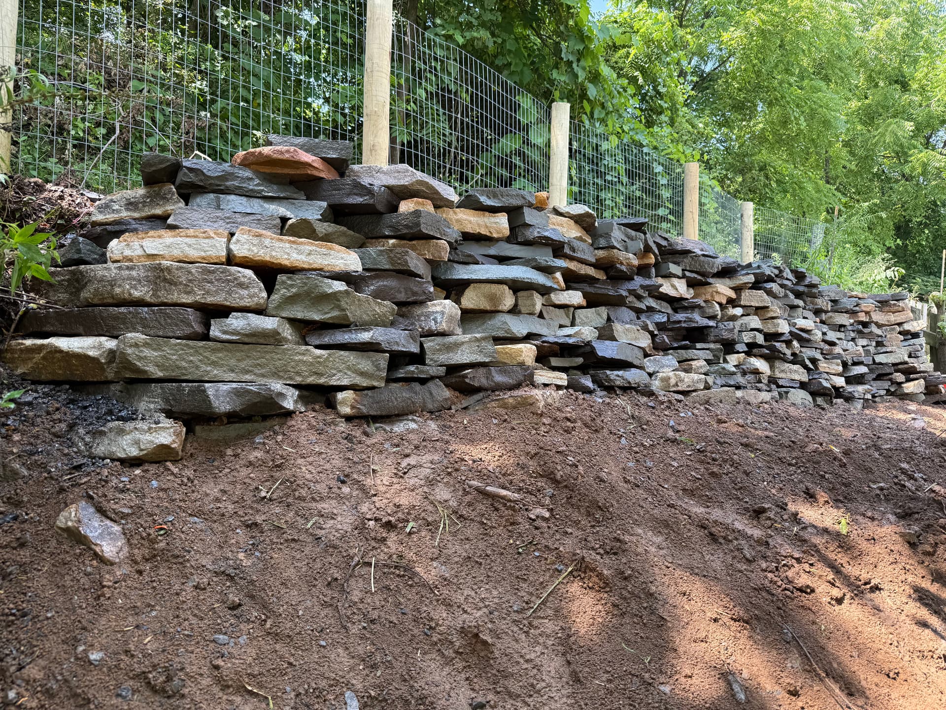Natural Stone Retaining Wall Built to Hold and Drain Right image